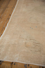 Reverse view of a vintage Oushak showing the hand-knotted foundation and processing marks.