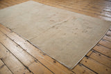 The hand-knotted foundation on the reverse of a vintage Oushak rug with visible processing numbers.