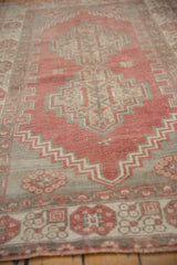 Distressed Oushak rug, close-up of stepped pale ruby and oxidized silver patterns.
