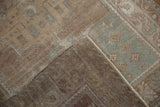 Vintage distressed Oushak rug's worn texture in beige, sand, and faded seafoam green patterns.