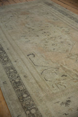 Distressed vintage Oushak carpet showcasing faded ivory tones and subtle traditional patterns.