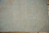 Detailed view of the hand-knotted texture and mostly even wear on a vintage Oushak.