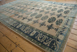 Elephant footprint gul motif with abrashes in sand, charcoal, and sea foam tones.
