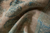 Textured pile of a vintage distressed Oushak carpet showing sand, sea foam geometric guls.
