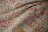 Distressed Sivas carpet texture with worn pile, displaying raspberry and mint floral patterns.