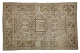 Vintage distressed Melas rug with central geometric medallion and faded neutral tones.