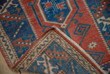 Distressed cranberry and indigo geometric pile with hand-knotted reverse.