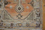 Distressed pile texture and faded geometric patterns on a vintage Oushak rug runner.