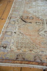 Distressed Oushak rug showing visible low pile, geometric border, and faded terracotta with slate tones.