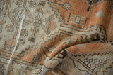 Textured close-up of distressed Oushak runner, showing low pile, wear, and tangerine geometric motifs.