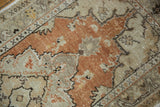 Distressed Oushak rug pile with burnt orange and beige, showing even wear and faint foundation.