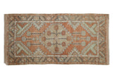 Distressed Oushak runner with terracotta, sea foam green, and silver floral medallion.