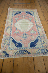 Distressed Oushak runner corner with pink, cobalt blue, and ivory geometric patterns.