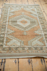 Intact side cord selvage of the distressed vintage Oushak rug, with a soft terracotta palette.