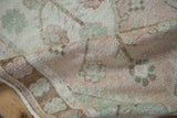 Evenly worn pile and muted beige, brown, and green floral design on distressed Oushak runner.