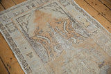Vintage distressed Oushak runner detail: geometric border with worn gold and ivory texture.