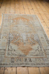 Distressed hand-knotted vintage Oushak runner, showing geometric border and faded dusty gold.