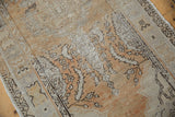 Vintage distressed Oushak runner's even wear, faint foundation, and muted gold patterns.