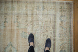 Distressed vintage Oushak carpet pile with mostly even wear and faded motifs.