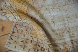 Distressed Oushak rug texture with exposed foundation, showing ivory, saffron, and brown tones.