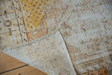 Distressed Oushak rug corner detail, highlighting worn pile, exposed foundation, and woven reverse.