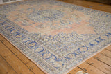 Distressed vintage Oushak corner with brilliant denim blue border, faded scalloped leaves.