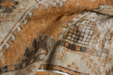 Folded Oushak runner showing distressed texture of copper and charcoal tones.