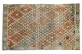 Distressed Vintage Tulu rug featuring a repeating lattice pattern in faded beige, orange, and blue tones, 2'11