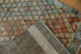 Distressed Tulu rug, faded beige, orange, blue lattice pile, and hand-knotted backing.