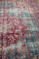 Angled view showing the distressed, low-worn pile of the vintage Sivas carpet.