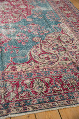 Worn knot heads and corner spandrel details on a distressed Turkish Sivas carpet.
