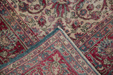 Corner of a distressed Sivas carpet folded over to reveal the hand-knotted weave and blue side cord.