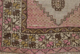 Worn mauve pile and geometric floral border on a Vintage Distressed Oushak runner corner.
