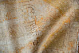 Distressed texture of a vintage Oushak rug with exposed foundation and saffron accents.