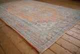 Distressed pile texture of vintage Oushak rug showing wear, faded terracotta and royal blue.
