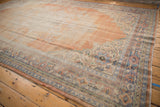 Distressed Oushak corner detail, pale rust, ivory, blue floral spandrel, textural pile.