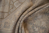 Muted beige, ivory, slate tones and softened geometric patterns on the distressed vintage Melas rug.