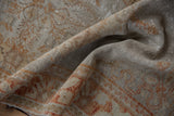 Distressed Oushak rug texture with soft pile and muted beige, pale rust blossom motif.