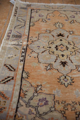 Distressed Oushak rug border featuring playful plant and serrate leaf motifs in sandalwood, silver.