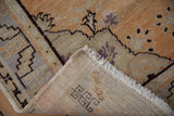 Hand-knotted reverse and fringe of a vintage distressed Oushak rug.