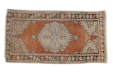 Vintage distressed Oushak runner with abrashed field, central medallion, dusty rust and beige tones.