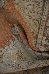 Folded distressed Oushak runner pile texture, showcasing rusty orange and beige abrash.