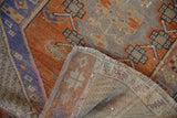 Distressed Oushak runner folded, showing its worn pile and woven reverse.