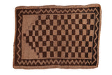 Distressed vintage Oushak rug mat, chocolate brown and beige checkered field, stepped mehrab, zig-zag border.