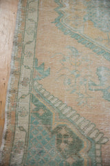 Detail of the distressed pile, showing the seafoam green and beige lattice corner spandrel.