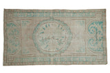 Distressed vintage hand-knotted Oushak runner, ivory and pale turquoise floral medallion, soft wear.
