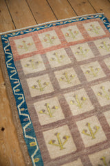 Distressed Oushak rug's multi-paneled tree of life design with ivory, terracotta, and indigo border.