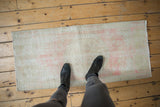 Distressed vintage Oushak rug runner, low textured pile in soft rose and ivory.