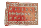 Distressed Oushak rug with abrashed dusty rose, cinnabar, geometric plant and starburst motifs.