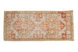 Vintage distressed Oushak runner with ivory, terracotta, and saffron geometric double medallion.